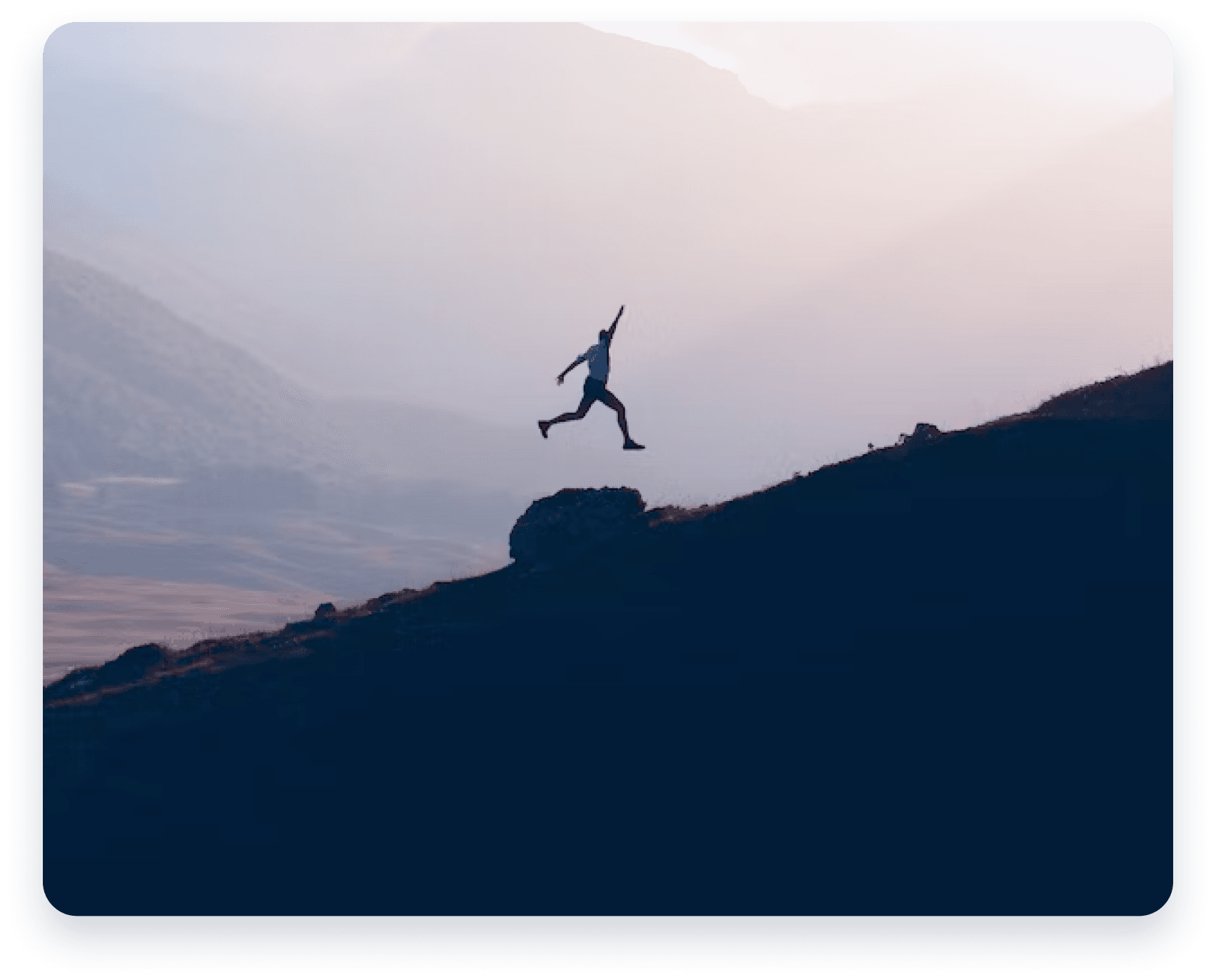 person jumping on mountain sunset